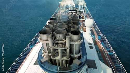 Black smoke from the chimneys of a cruise ship. Aerial view of a cruise ship in open water. Air Exhausting HD Slow motion. Vietnam. 4K photo