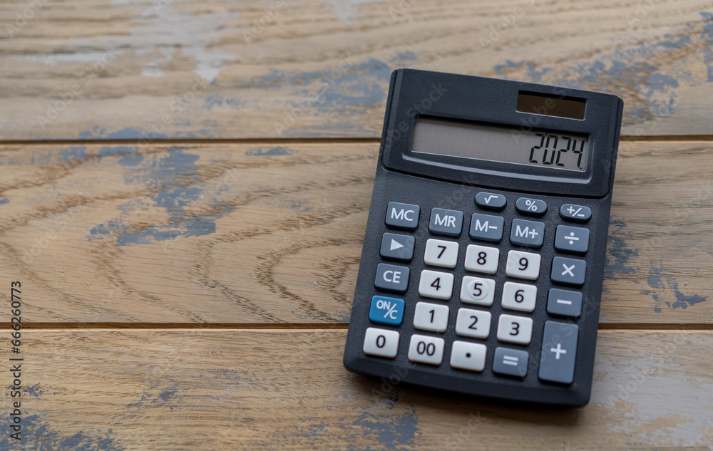 Calculator with the number 2024 on the display. Concept of finance, taxes, savings and economic crisis.