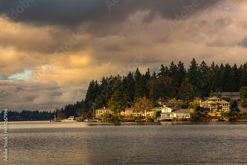 2019-12-13 MERCER ISLAND SHORELINE WITH LAKE WASHINGTON BEAUTIFUL FOLIAGE AND HOMES WITH A CLOUDY SKY photo