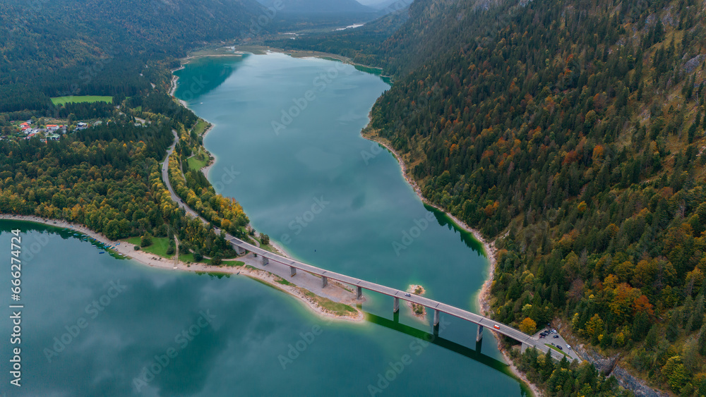 Aerial drone view of Faller-Klamm-Brucke bridge over Silvenstein lake, Karwendel mountain range Alps, Upper Bavaria, Germany in auttumn.