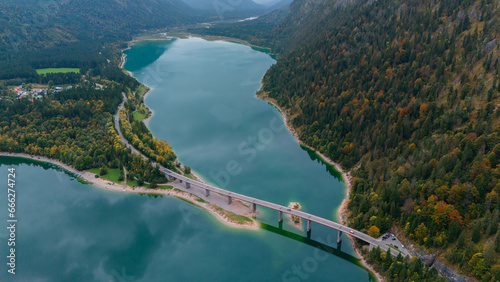 Aerial drone view of Faller-Klamm-Brucke bridge over Silvenstein lake, Karwendel mountain range Alps, Upper Bavaria, Germany in auttumn.