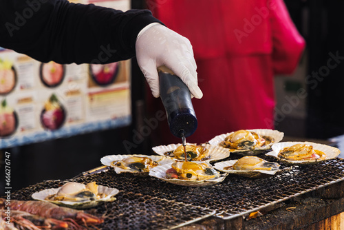 chef at a street kitchen preparing seafood at Tsukiji-market in Tokyo, Japan