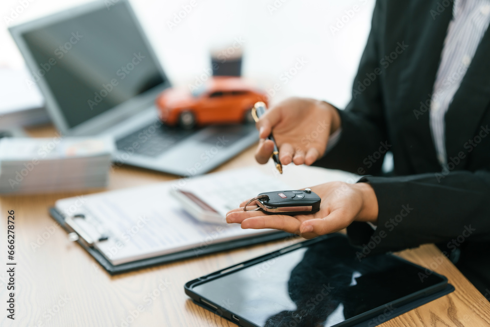 Pretty Asian businesswoman confidently handling funds for new vehicle loan, depicting financial independence and pursuit of luxury, success, modern transportation. lending money on new car loan - obrazy, fototapety, plakaty 