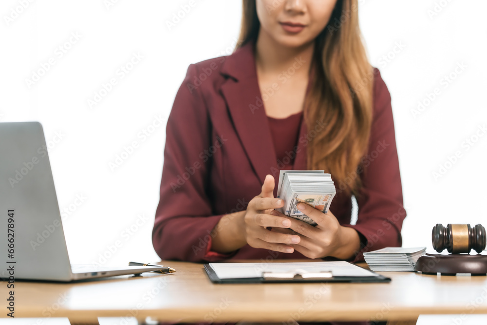 Fototapeta premium Young Asian female lawyer people reviewing legal documents at desk, embodying reliability, dedication in legal profession, reading announcement. Court convicting defendant according to criminal law