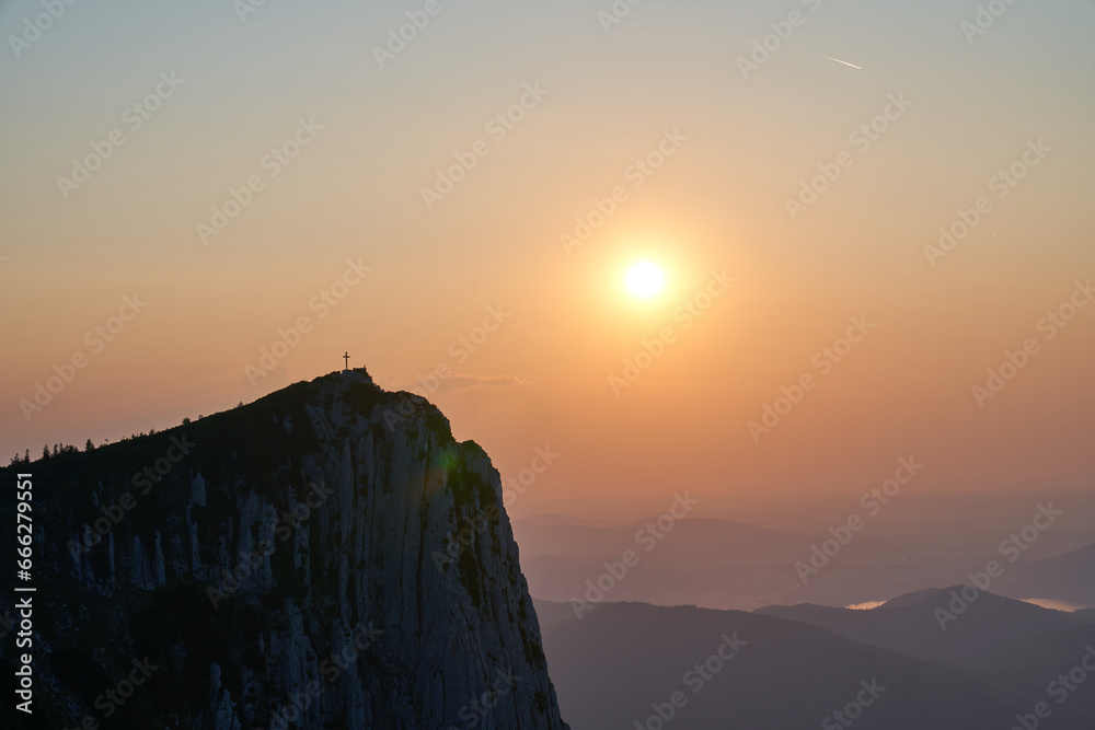 Cross in the mountains and incredible sunset. Upper Austria.