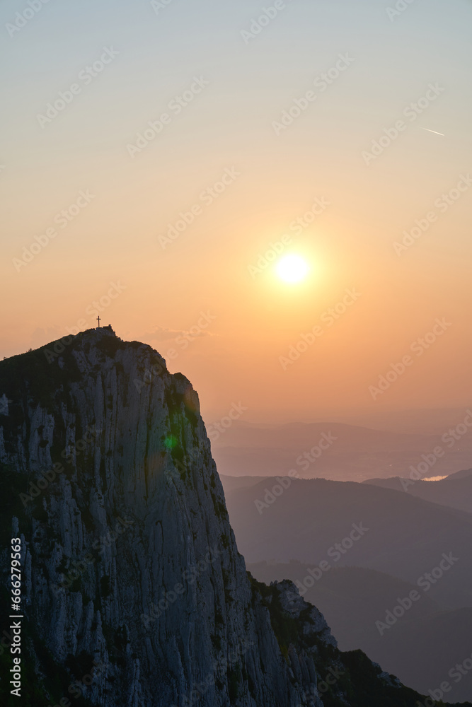 Cross in the mountains and incredible sunset. Upper Austria.