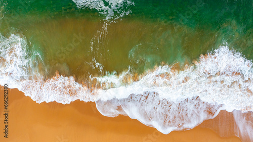 Fototapeta Naklejka Na Ścianę i Meble -  Wave on the beach with sand and turquoise waves aerial view