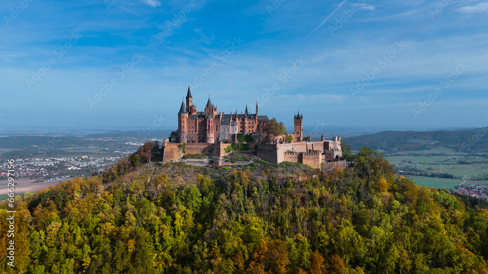 Aerial drone view of medieval Hohenzollern castle on top of hill in autumn, Baden-Wurttemberg, Germany
