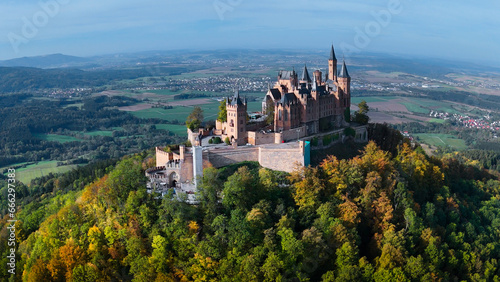 Aerial drone view of medieval Hohenzollern castle on top of hill in autumn, Baden-Wurttemberg, Germany photo