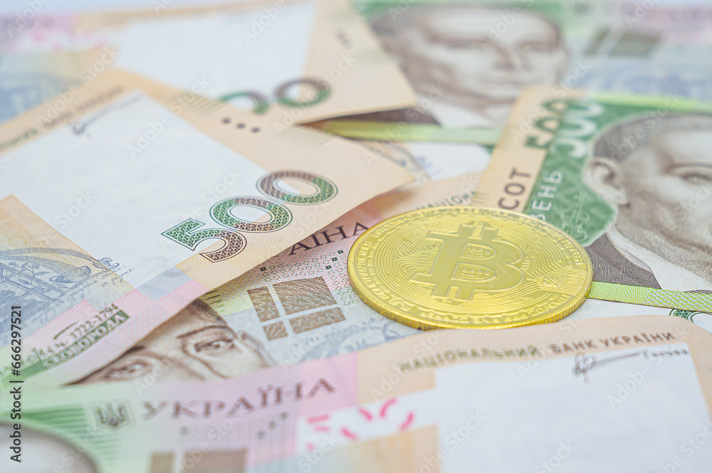 Bitcoin in Ukraine. Bitcoin exchange. Bitcoin exchange rate to Ukrainian currency. Use of blockchain technology in Ukraine. Golden bitcoin on five hundred ukrainian hryvnia bills background Bitcoin in Ukraine. Bitcoin exchange. Bitcoin exchange rate to Ukrainian currency. Use of blockchain technology in Ukraine. Golden bitcoin on five hundred ukrainian hryvnia bills background
