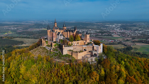 Aerial drone view of medieval Hohenzollern castle on top of hill in autumn  Baden-Wurttemberg  Germany