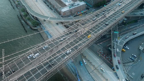 Overhead view above Brooklyn bridge above S street viaduct on Manhattan, NYC USA. Busy traffic in American city background 4K aerial. Scenic rush hour with cars and people crossing Brooklyn bridge  photo