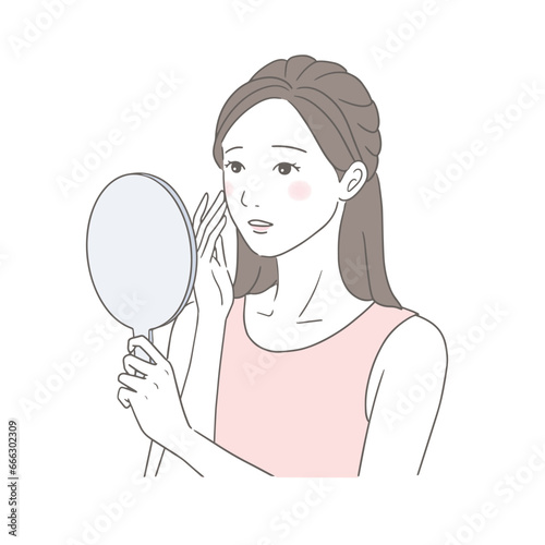 鏡を見てお肌の変化に悩む女性