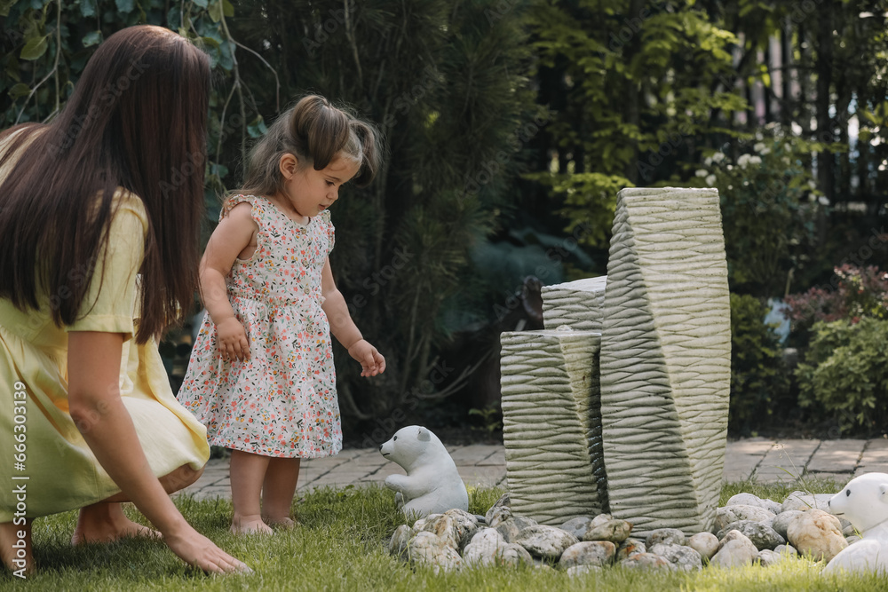Fototapeta premium Mother with her cute daughter spending time together in park