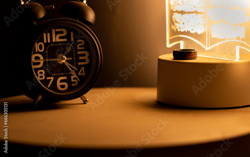 Close-up of a black alarm clock at 01:00 AM, early morning