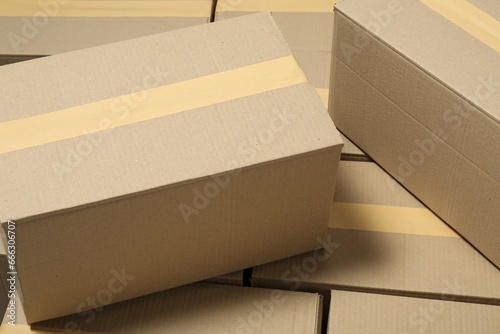Many closed cardboard boxes with tape as background © New Africa