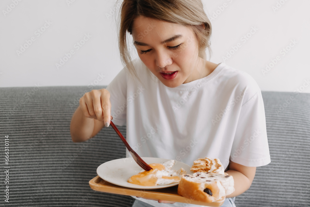 Portrait of asian woman eating her simple and easy breakfast. Portrait of asian woman eating her simple and easy breakfast.