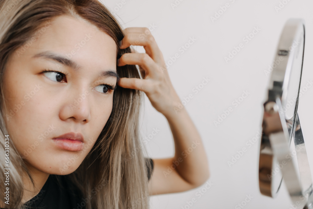Woman woman wearing make up and checking her skin at the mirror. Woman woman wearing make up and checking her skin at the mirror.