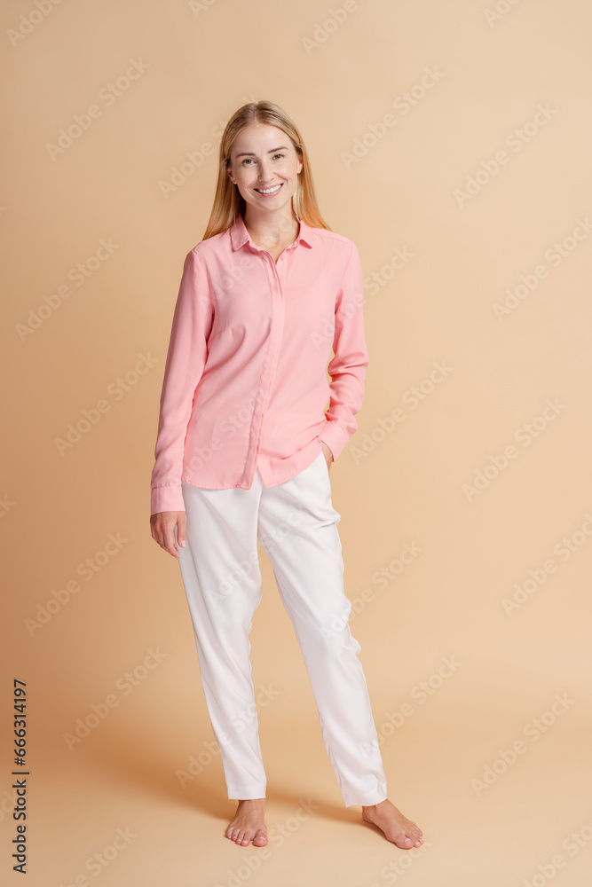 Obraz premium Young woman smiling posing wearing casual clothes on beige background