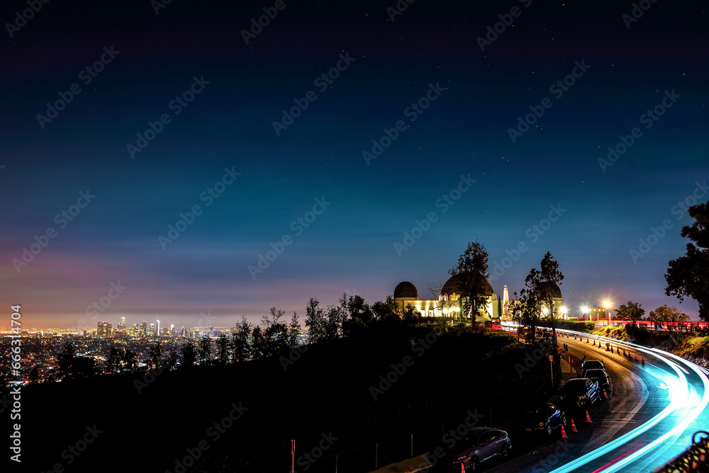 Light Trails on the Road to Griffith Observatory with a View to Los Angeles Skyline - California, USA Light Trails on the Road to Griffith Observatory with a View to Los Angeles Skyline - California, USA
