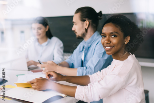 Diverse colleagues working at table in office