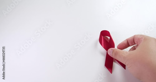 Placing a red ribbon on the right side of the frame which signifies the HIV-AIDS worldwide disease awareness and prevention. photo
