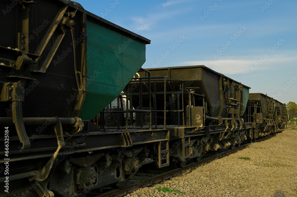 Train cars carrying iron ore are lined up on the tracks waiting to be loaded Train cars carrying iron ore are lined up on the tracks waiting to be loaded