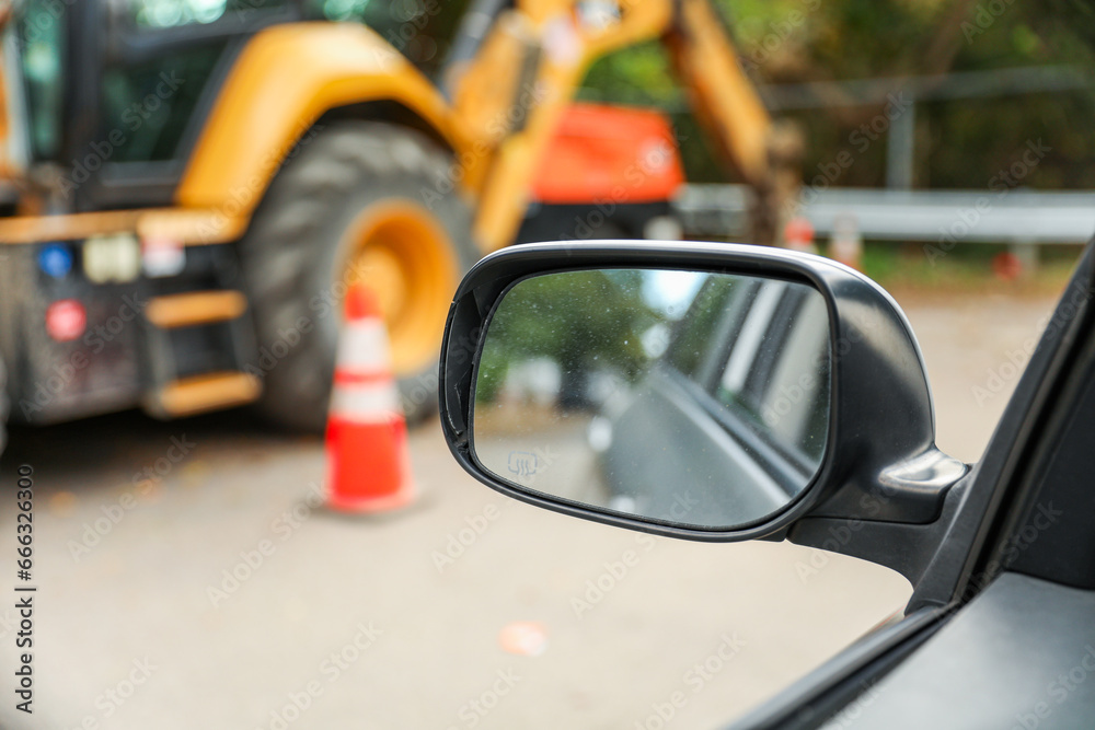 car mirror reflecting urban cityscape, capturing the essence of modern travel and self-reflection