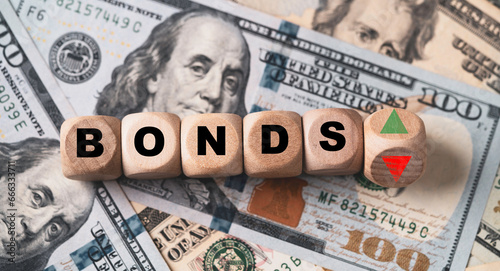 Quadro su tela Bonds wording with up and down on USD dollar banknote for Bonds yield return of United States of America interest increasing and decreasing concept