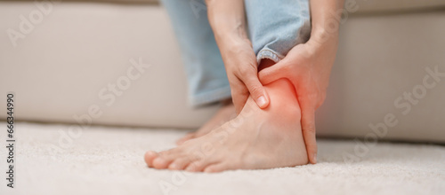 Fotografie woman having leg pain due to Ankle Sprains or Achilles Tendonitis and Shin Splints ache