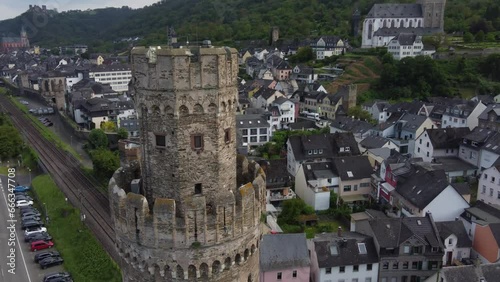 Freight Train transporting Cargo Containers passing Medieval Ox Tower of Oberwesel Town, Germany. Aerial photo