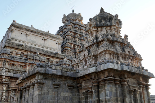 Tower of Airavatesvara Temple, Darasuram, Kumbakonam, Tamilnadu. Ancient hindu temple tower with carvings of God sculpture isolated against blue sky background in Tamilnadu.