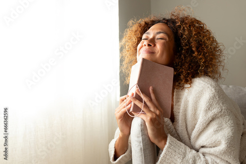 Фотография Hispanic female making wish in personal journal