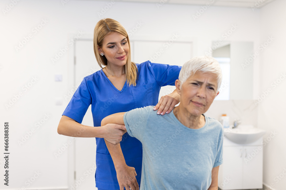 Doctor or Physiotherapist working examining treating injured arm of senior patient, stretching and exercise, Doing the Rehabilitation therapy pain in clinic. Doctor or Physiotherapist working examining treating injured arm of senior patient, stretching and exercise, Doing the Rehabilitation therapy pain in clinic.