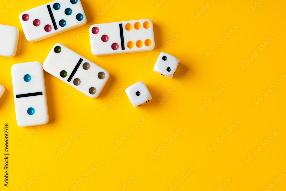 Domino tiles on yellow background studio shot Domino tiles on yellow background studio shot