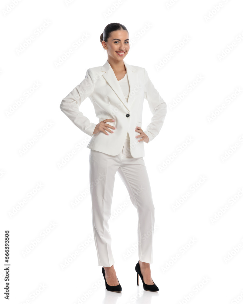 confident woman with bun hair holding hands on hips and smiling confident woman with bun hair holding hands on hips and smiling