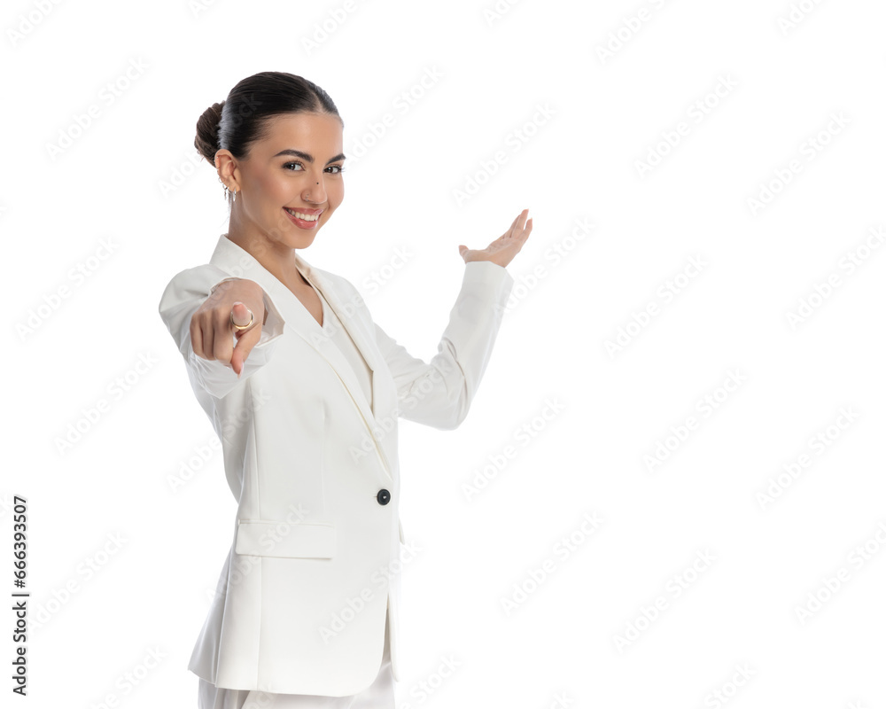 side view of happy elegant woman showing to side and pointing finger forward side view of happy elegant woman showing to side and pointing finger forward