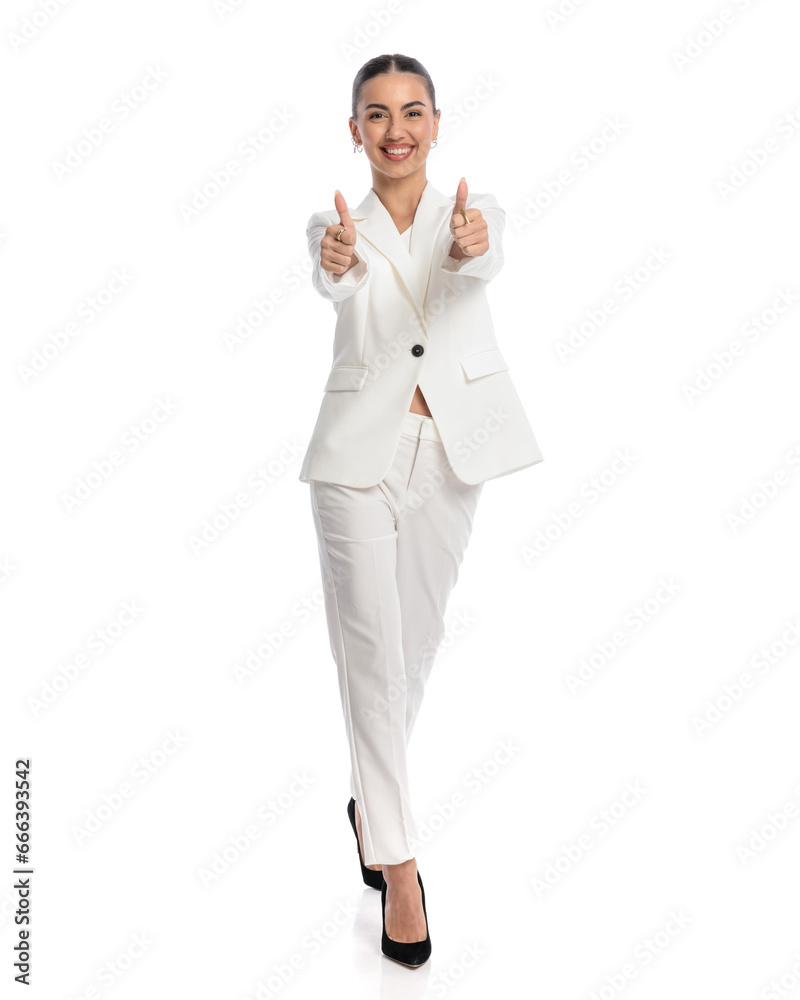 elegant fashion girl making thumbs up sign, smiling and walking elegant fashion girl making thumbs up sign, smiling and walking