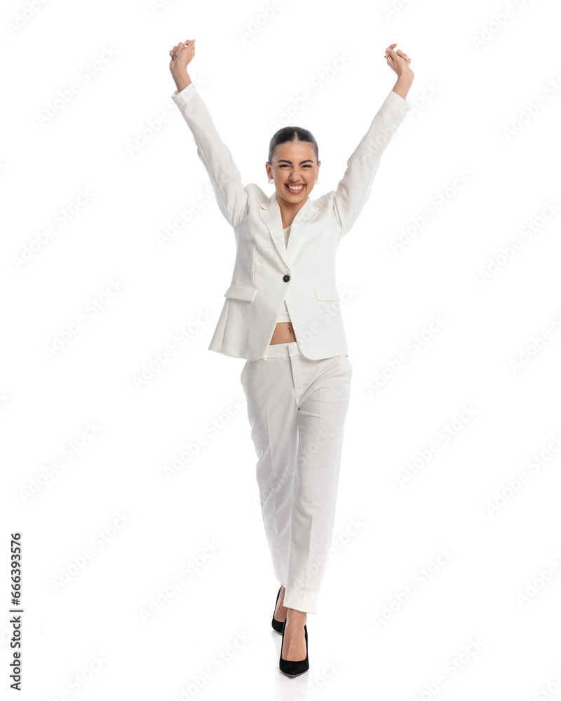 excited young woman holding arms above head and cheering excited young woman holding arms above head and cheering