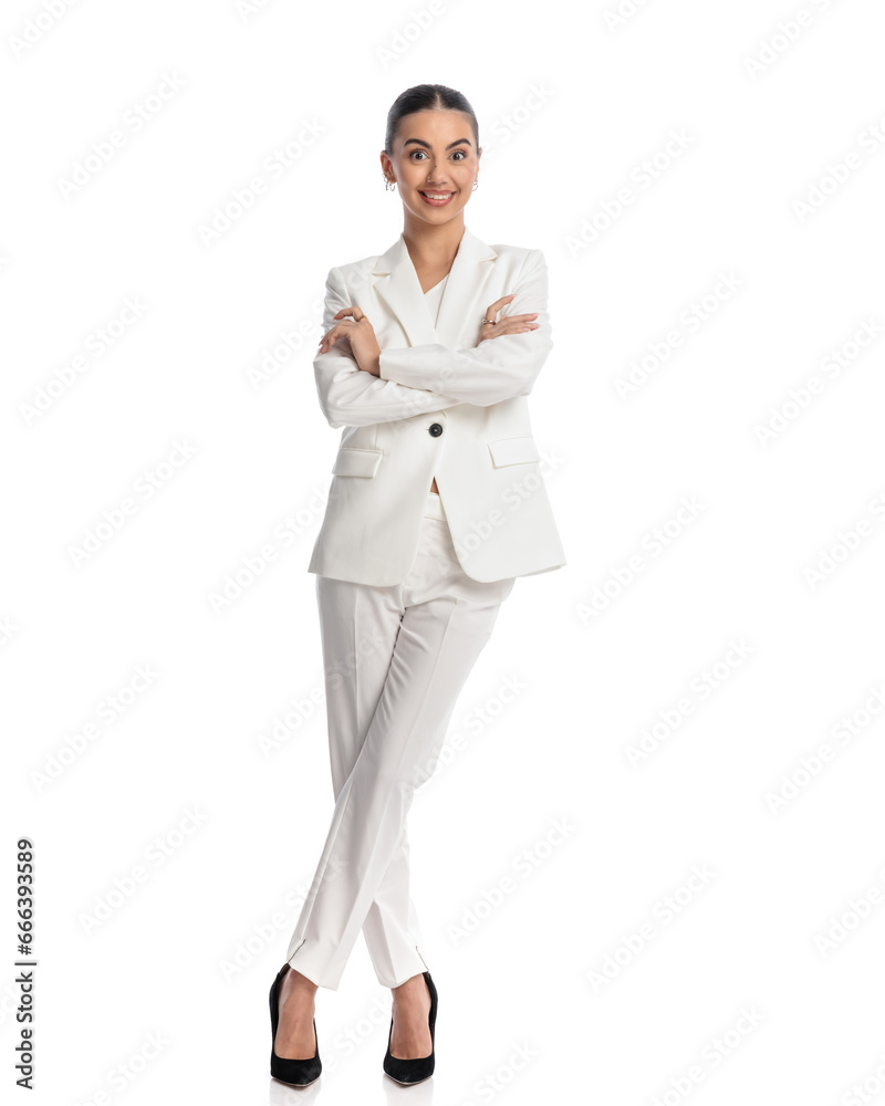 excited elegant girl in white suit folding arms and smiling excited elegant girl in white suit folding arms and smiling