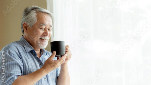 Senior male feel happy drinking coffee in the morning, enjoying time in his home indoor background - lifestyle senior happiness concept