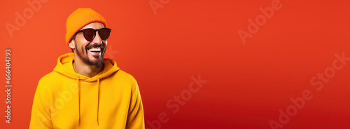 Portrait of happy young handsome man smiling on bright colors studio background   Attractive cheerful man having fun banner with copyspace