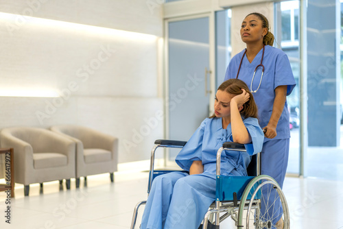 Portrait of caring nurse woman service help support discussing and consulting care with sick patien sitting in wheelchair at hospital corridor, caregiver, recovery.healthcare and insurance