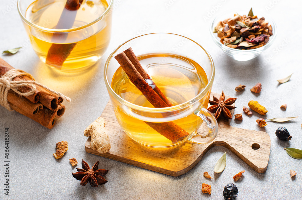 Autumn or Winter Hot Tea, Herbal Tea with Spices on Bright Background Autumn or Winter Hot Tea, Herbal Tea with Spices on Bright Background