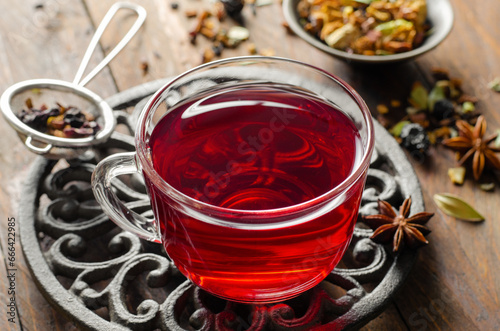 Herbal Tea, Hibiscus Red Tea in Glass Cup on Wooden Background, Autumn or Winter Drink