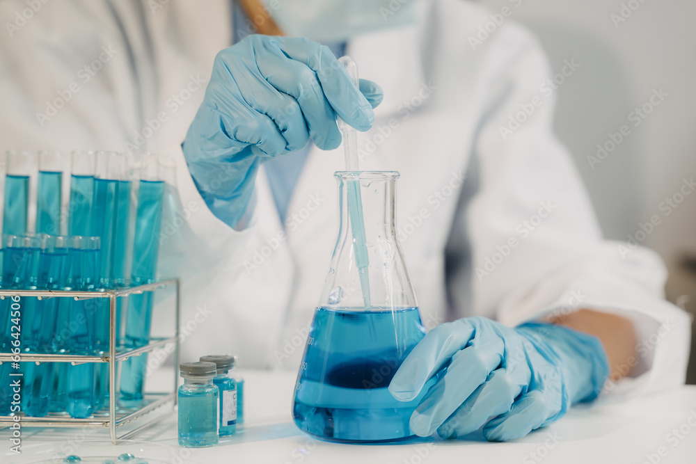 Female scientist researcher conducting an experiment working in the chemical laboratory. Female scientist researcher conducting an experiment working in the chemical laboratory.