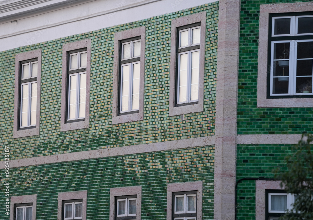 the windows of a building. detail. the facade of a building photographed during the day.
