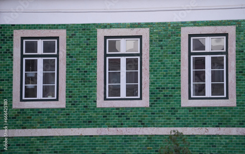 the windows of a building. detail. the facade of a building photographed during the day.