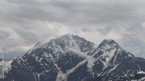 View on mountains and blue sky above clouds. Time-lapse.