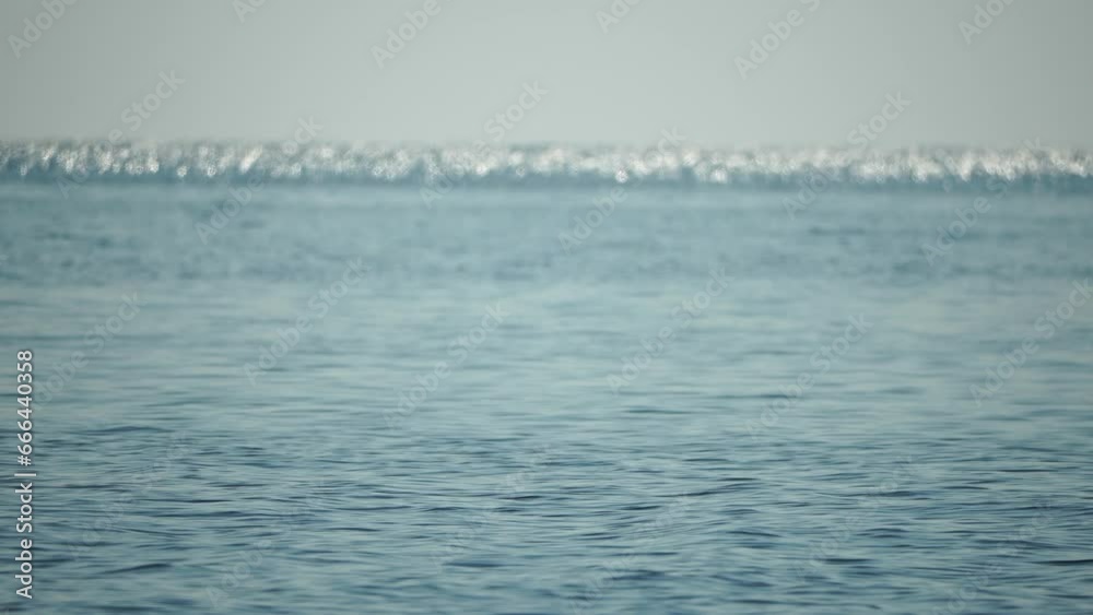 Sea water surface. Low angle view over clear azure sea water. Sun glare. Abstract nautical summer ocean nature. Holiday, vacation and travel concept. Nobody. Slow motion. Weather and climate change Sea water surface. Low angle view over clear azure sea water. Sun glare. Abstract nautical summer ocean nature. Holiday, vacation and travel concept. Nobody. Slow motion. Weather and climate change
